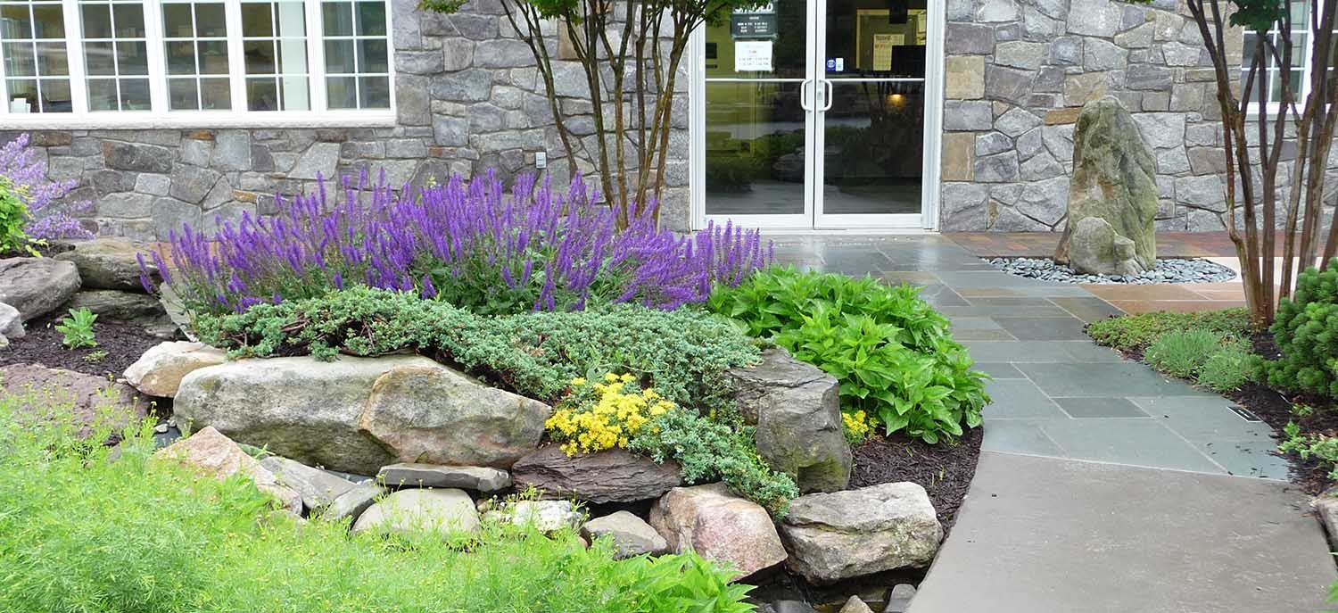 Flagstone entranceway with decorative boulders, building stone